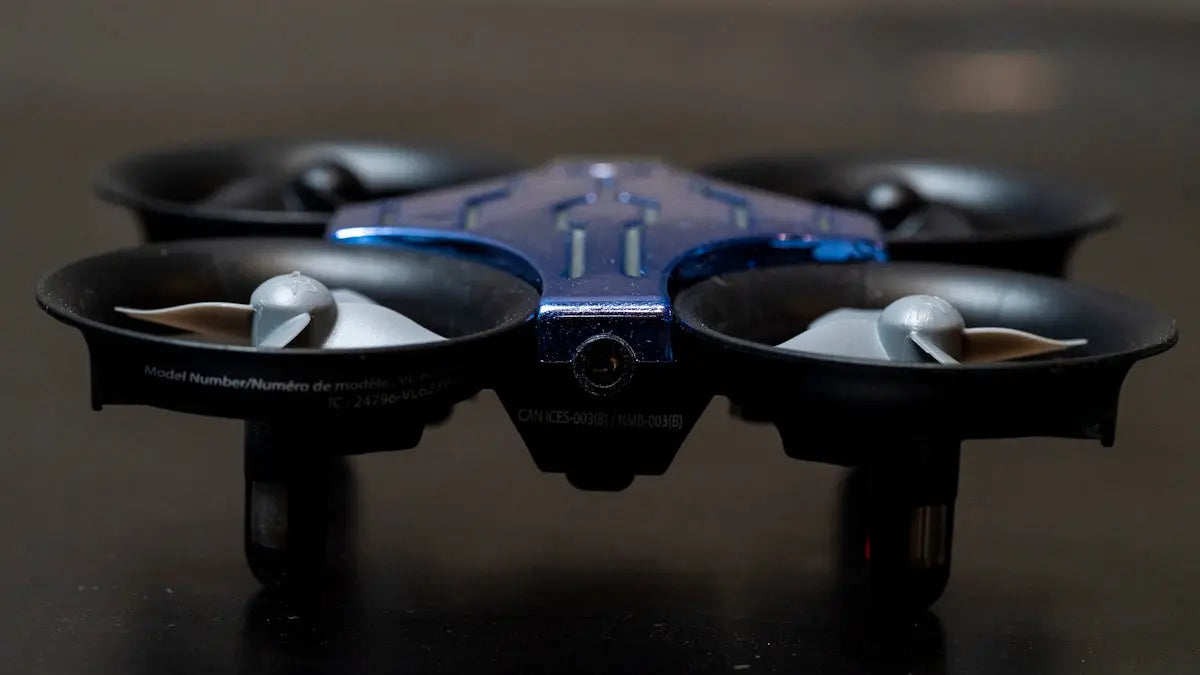 a close up of a blue and black flying device