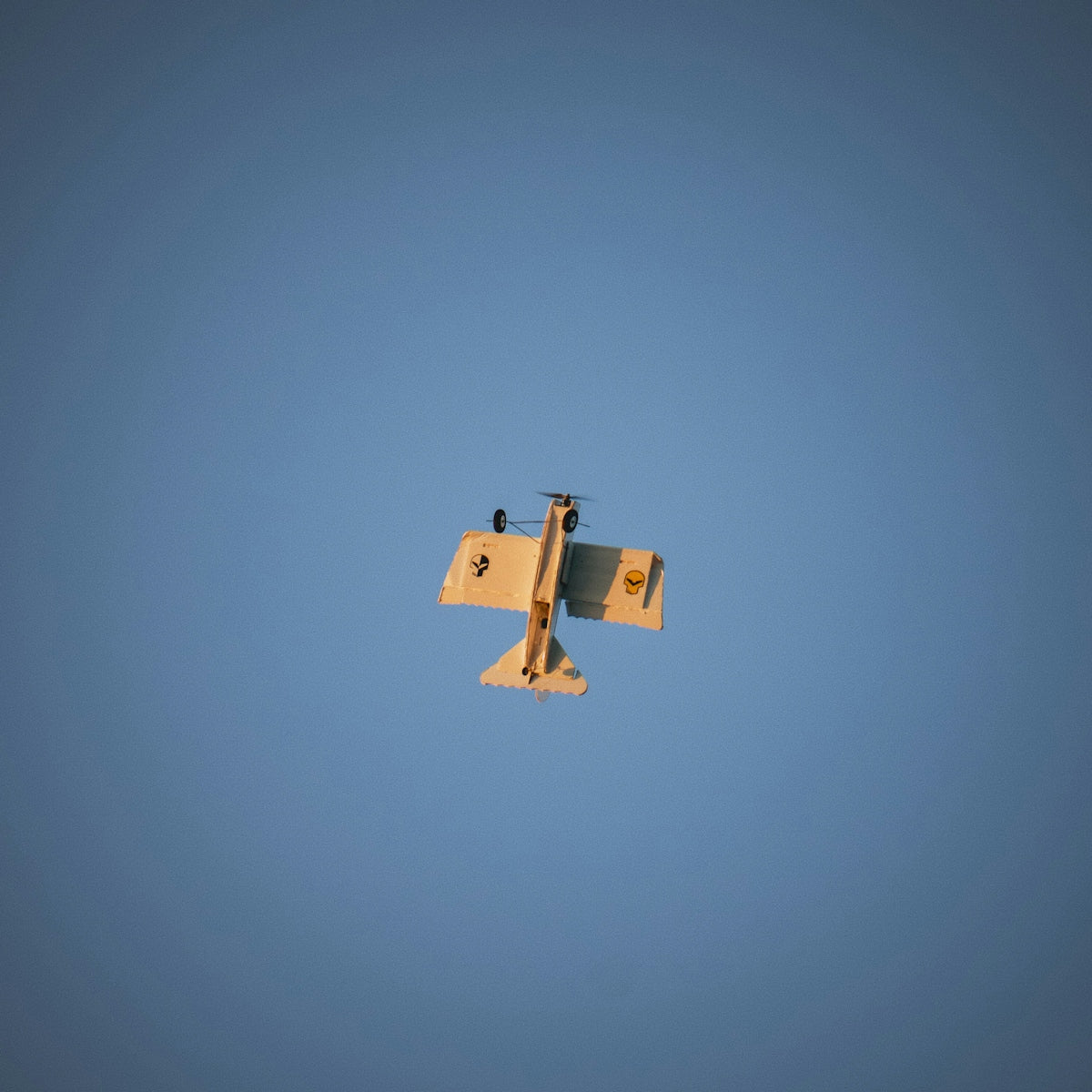 an airplane is flying in the blue sky