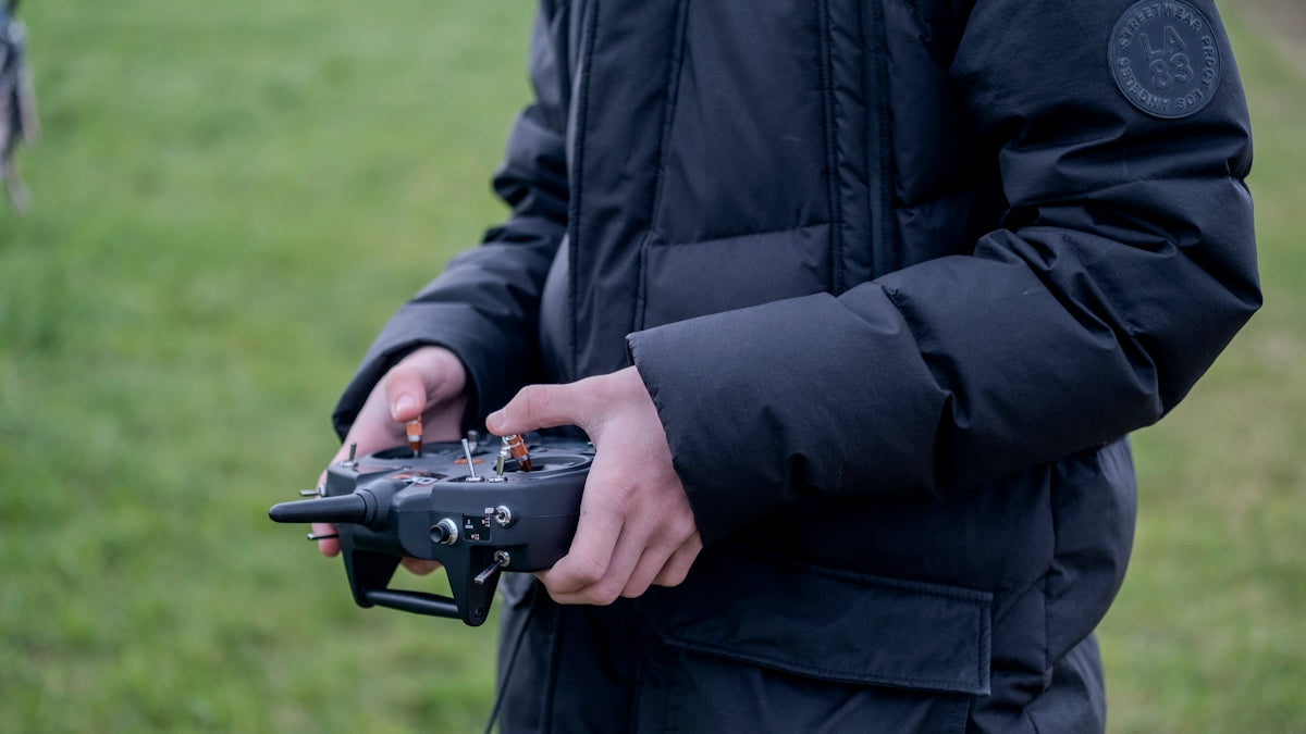 a person holding a remote control device in their hands