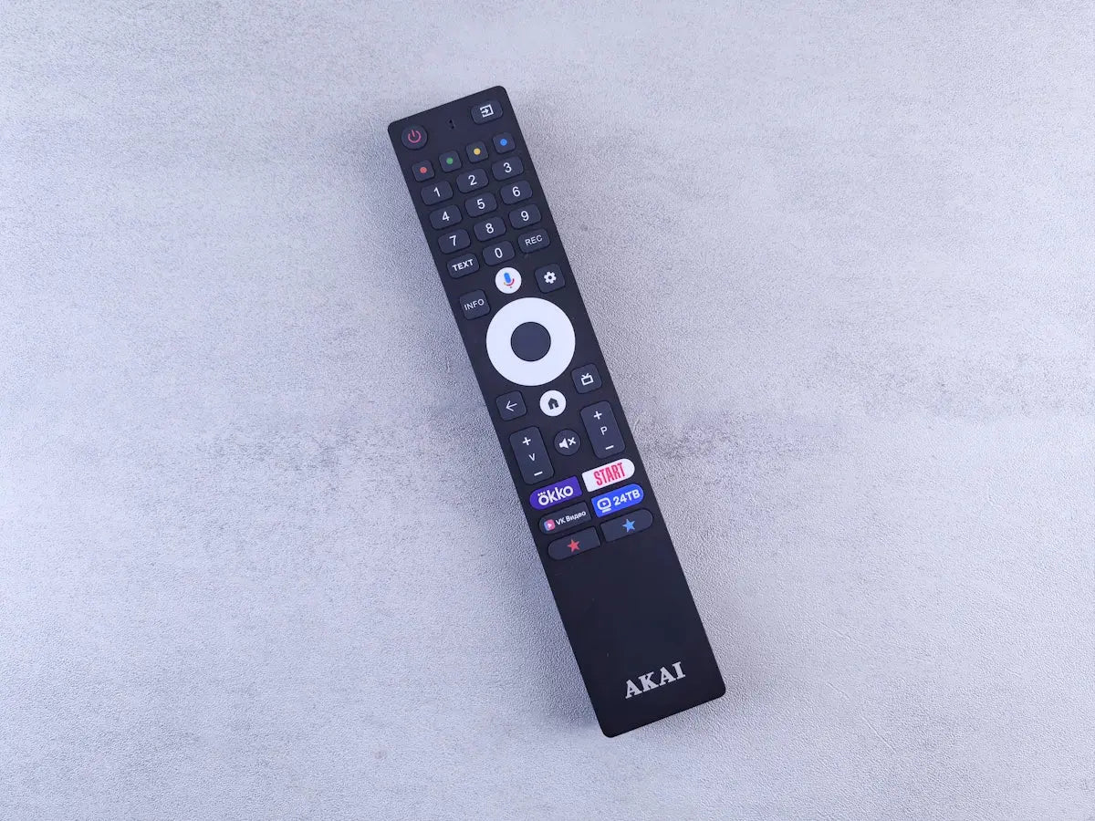 A close up of a remote control on a white surface