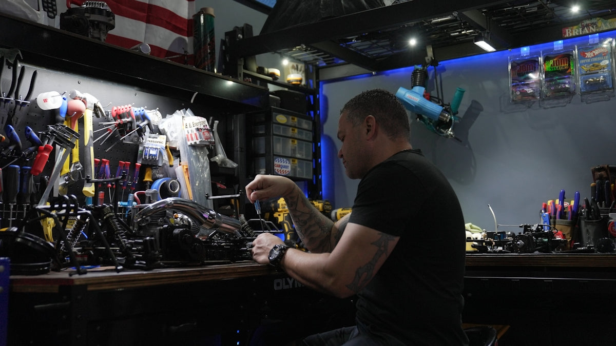 A man sitting at a bar working on a machine