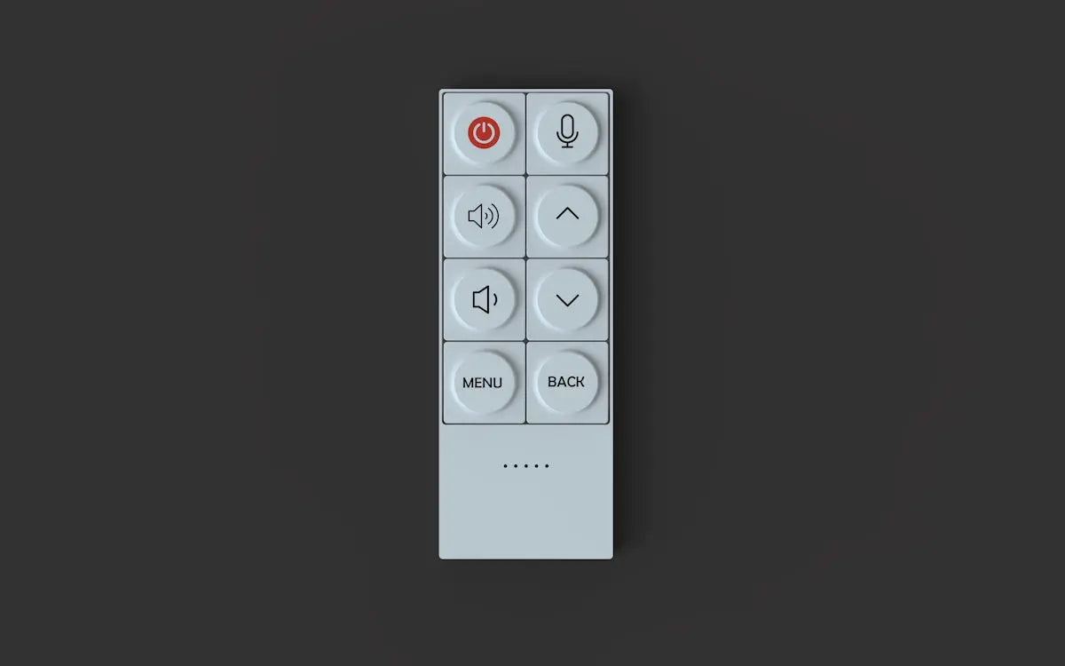 A white remote control with circular buttons.