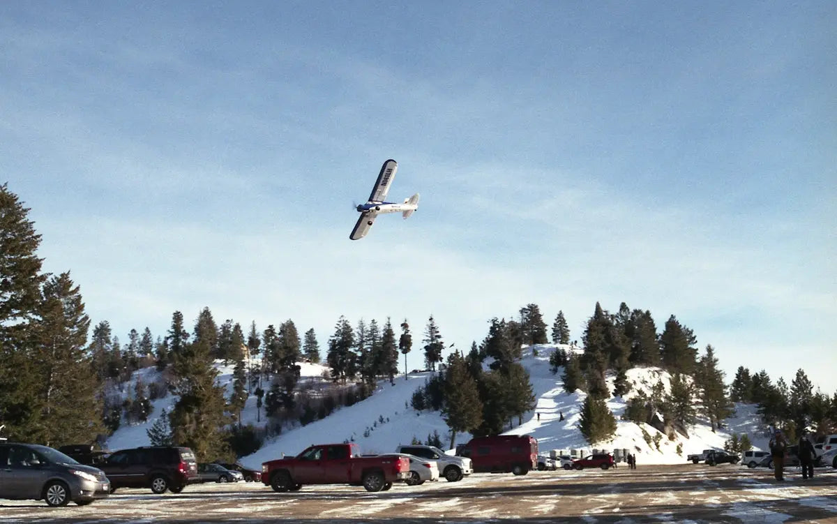 a plane flying over a parking lot