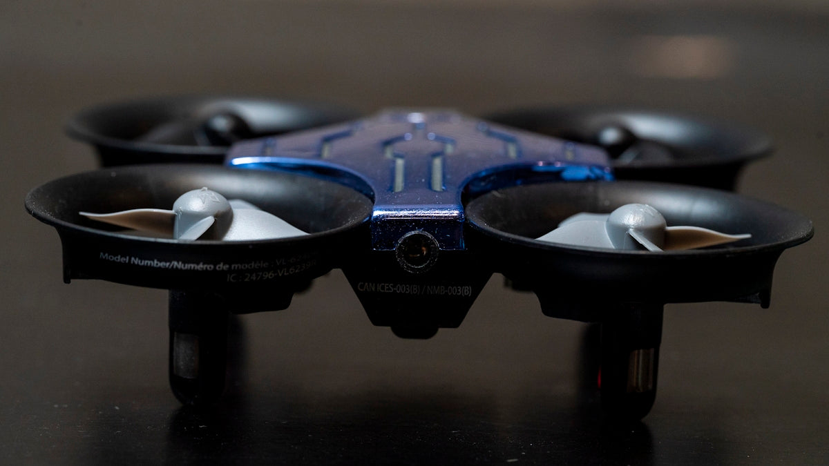a close up of a blue and black flying device