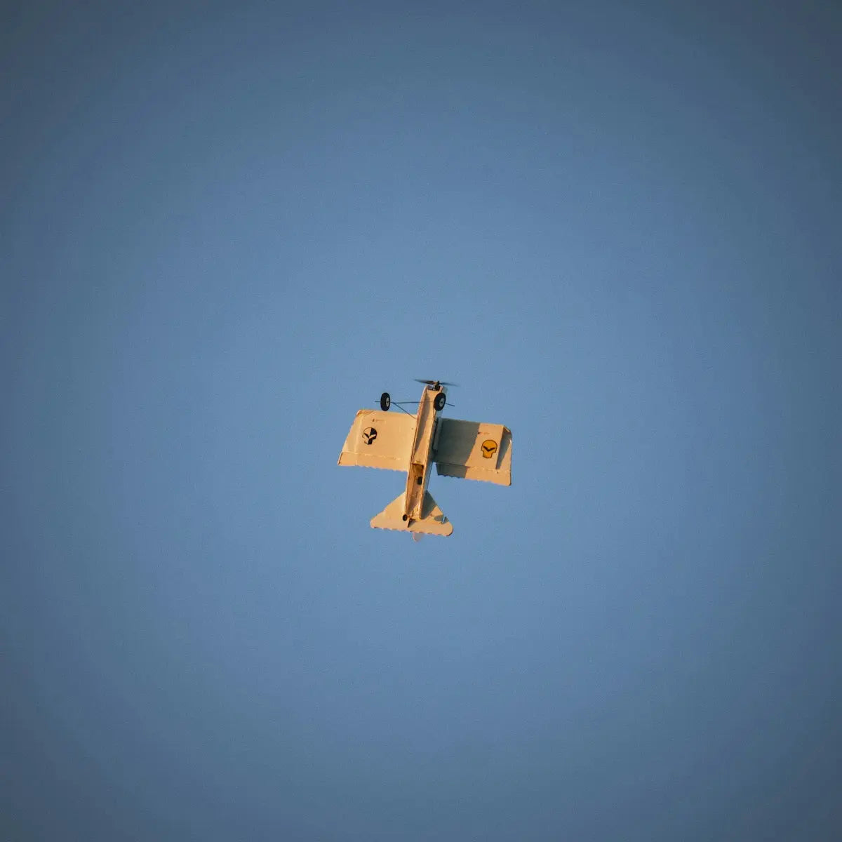 an airplane is flying in the blue sky