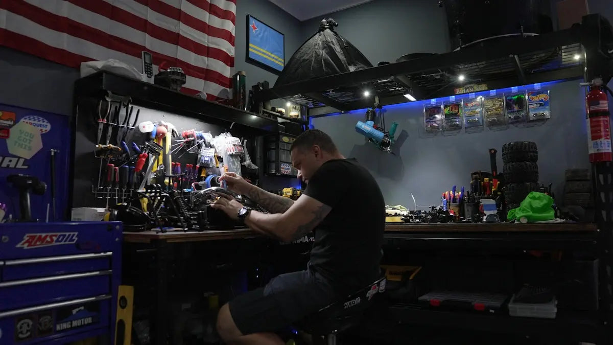 A man sitting at a workbench in front of an american flag